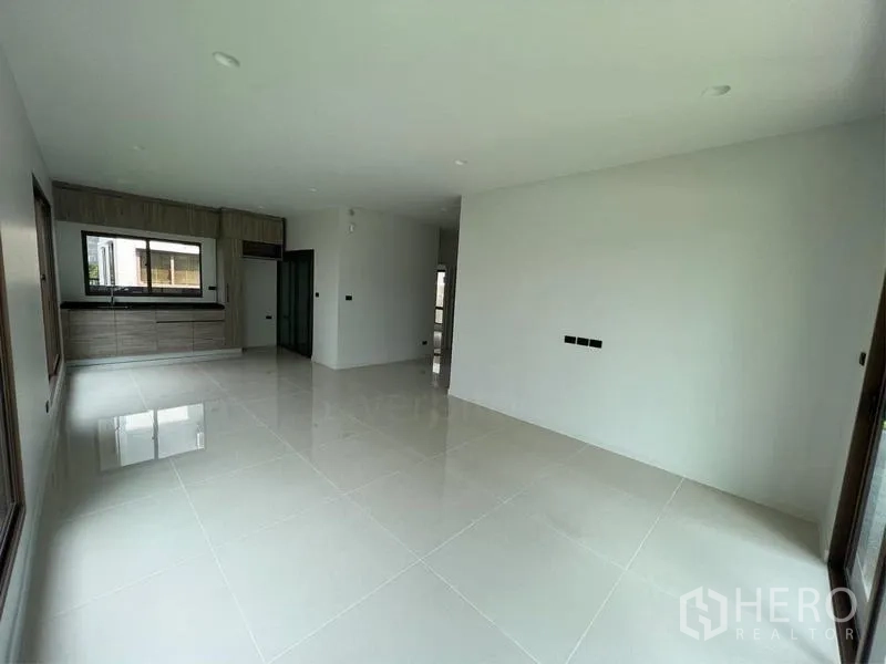 Detached House for sale in Bang Kapi, Bangkok - Open dining and kitchen space with built-in cabinets and a large window.