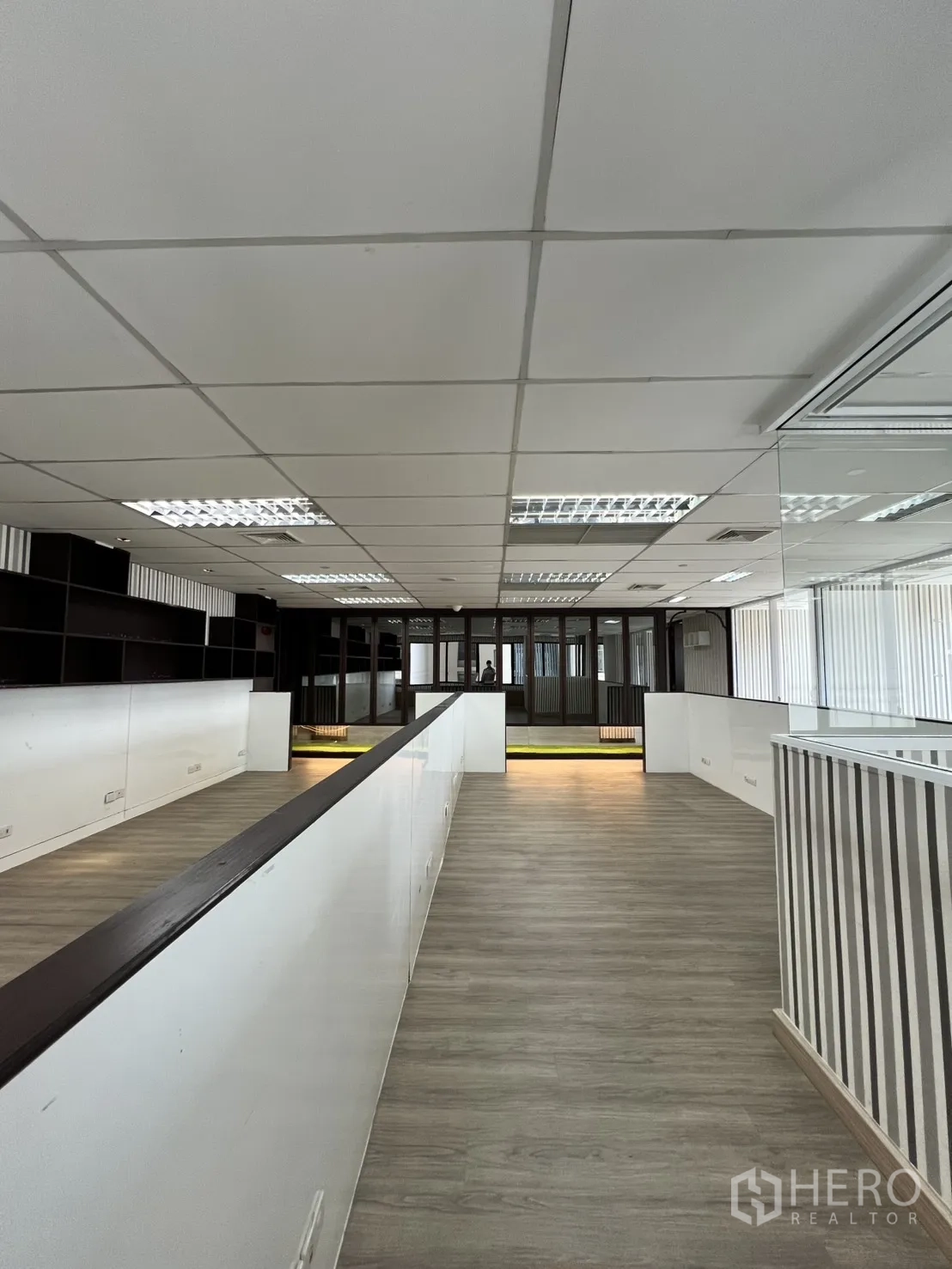 Office Space for rent in Watthana, Bangkok - Deep open workspace with long central divider and vinyl floors.