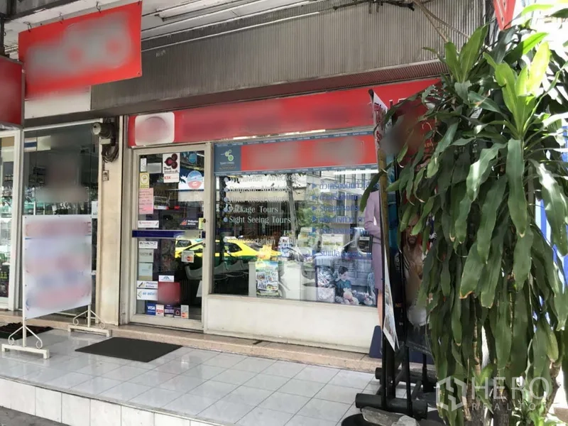 Retail Space for rent in Watthana, Bangkok - Street-level retail shopfront with glass façade, red signage band, tiled entrance and covered sidewalk near BTS Asok in Sukhumvit.