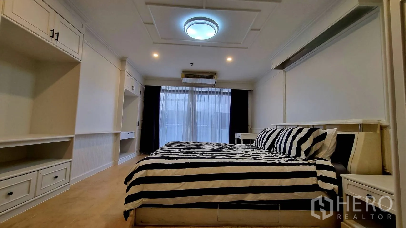 Condominium for rent in Watthana, Bangkok - Master suite with extensive cabinetry on both sides.