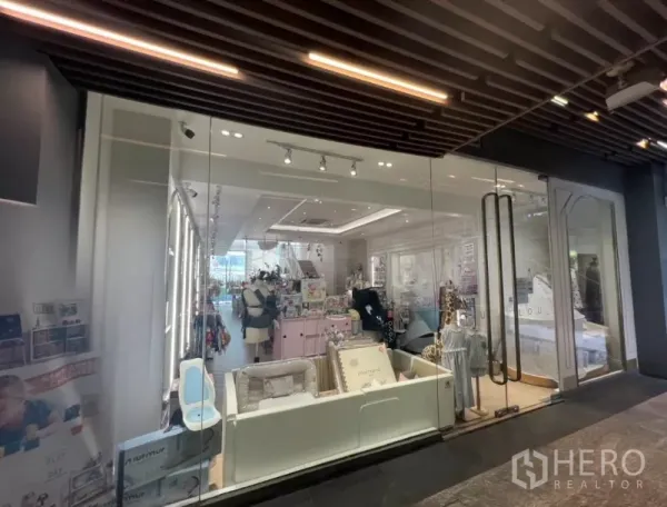 Retail Space for rent in Watthana, Bangkok - Modern shopfront with clear glass panels and wood slat ceiling above the walkway.