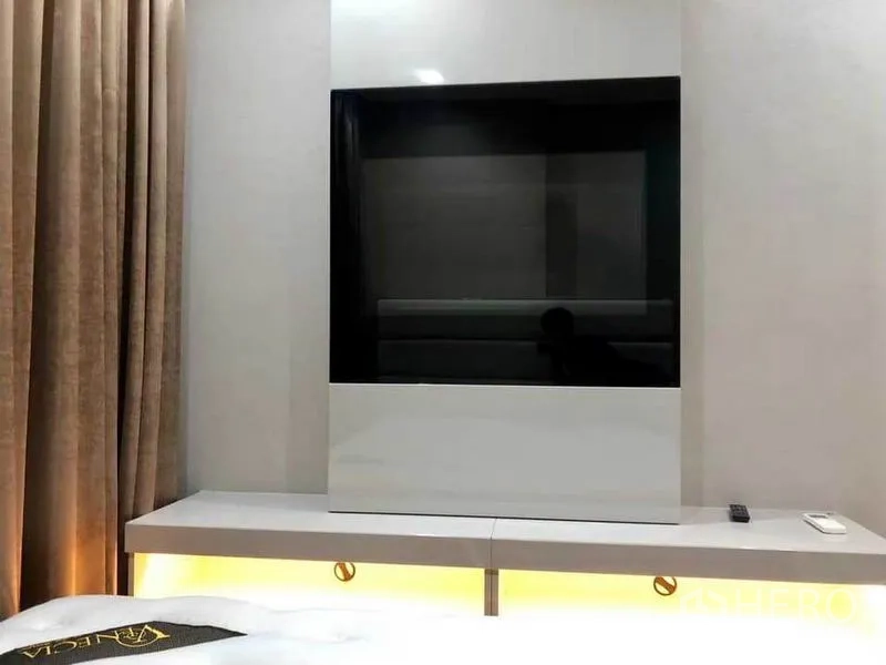 Condominium for rent or sale in Phaya Thai, Bangkok - Wall-mounted TV unit and console with soft under-cabinet lighting in the bedroom.