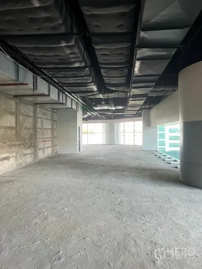Retail Space for rent in Bang Rak, Bangkok - Shell retail floor with exposed HVAC and floor-to-ceiling corner windows in Silom.
