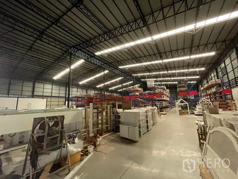 Warehouse for rent in Lat Krabang, Bangkok - Expansive warehouse interior with high-bay shelving and polished concrete floors.