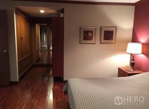 Condominium for rent or sale in Watthana, Bangkok - Bedroom view toward dressing area with built-in wardrobes.