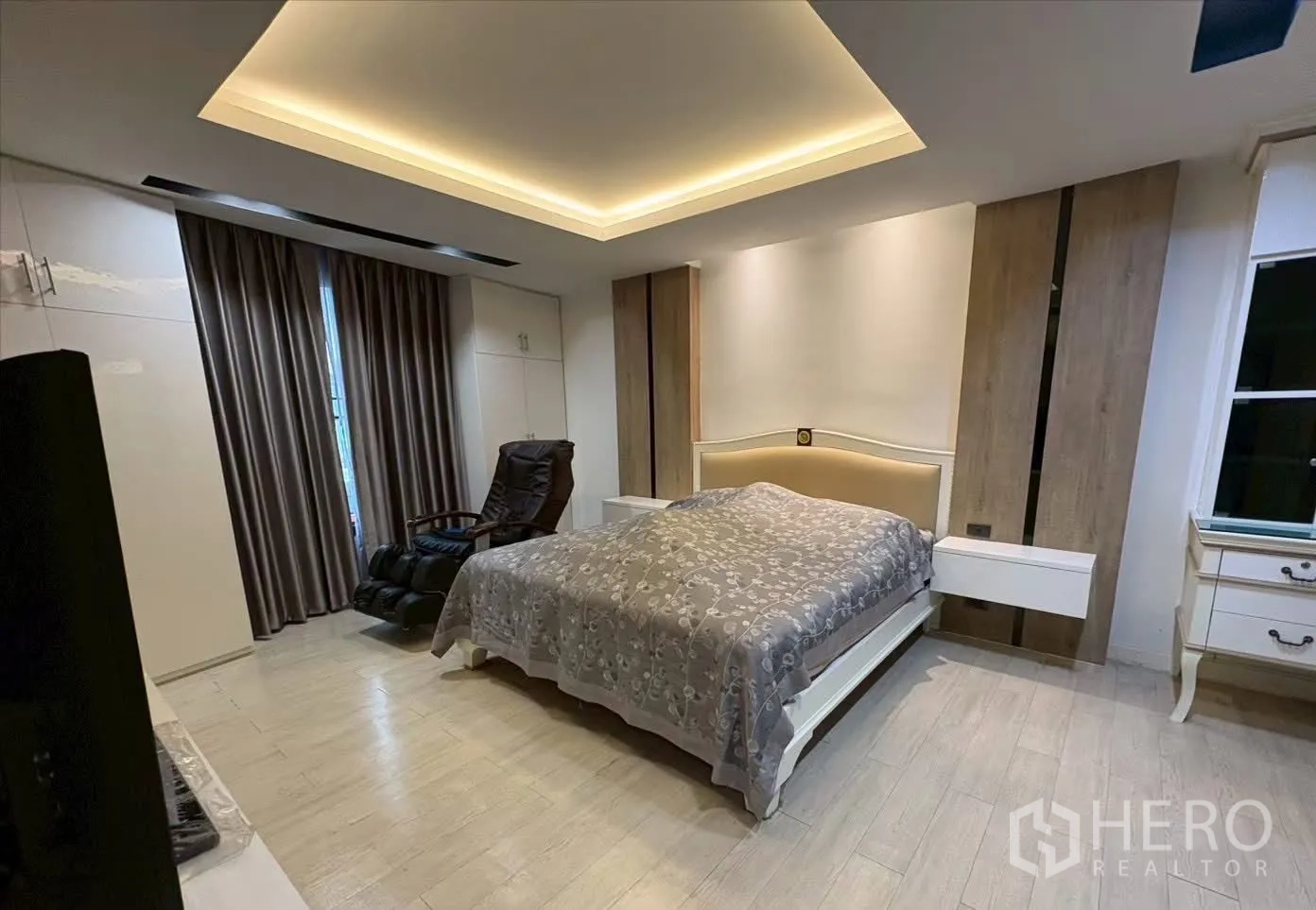 ทาวน์เฮาส์ for rent in Pathum Wan, Bangkok - ห้องนอนมาสเตอร์พร้อมไฟซ่อนฝ้า เตียง เก้าอี้นวด และโต๊ะข้าง.