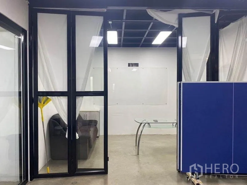 Home Office for rent or sale in Bang Khae, Bangkok - Meeting room with glass doors, sofa corner and ceiling lights.