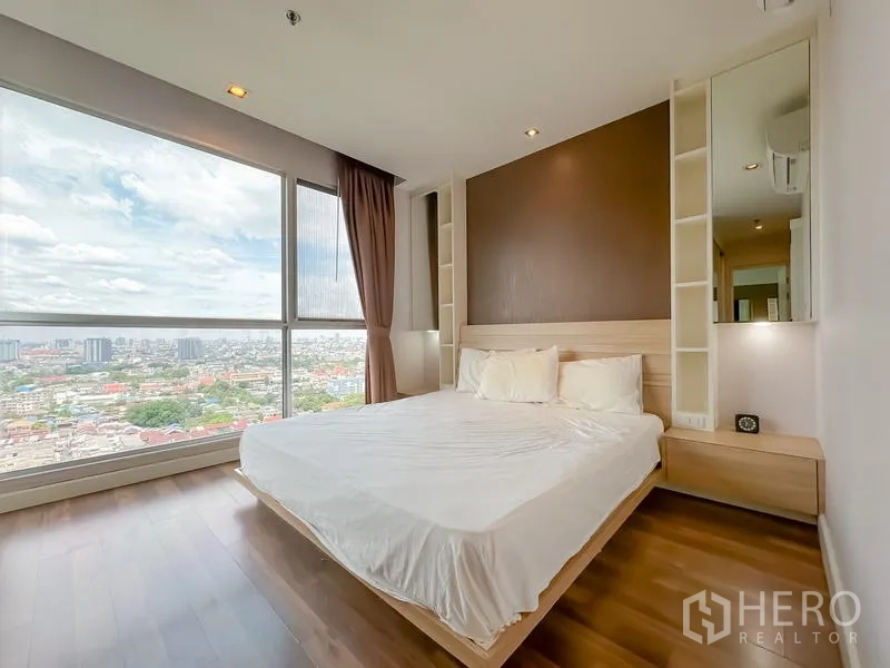 Condominium for sale - Master bedroom with king bed, built-in side shelves and panoramic corner windows.