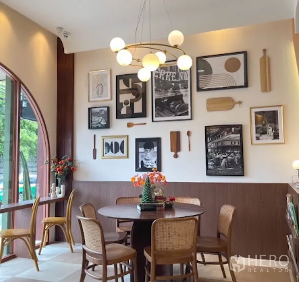Retail Space for rent in Watthana, Bangkok - Dining corner with statement chandelier, framed art, and rattan chairs.