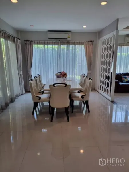 Detached House for rent in Mueang Nonthaburi, Nonthaburi - Eight-seat dining table beside floor-to-ceiling curtains and sliding glass doors to the garden.