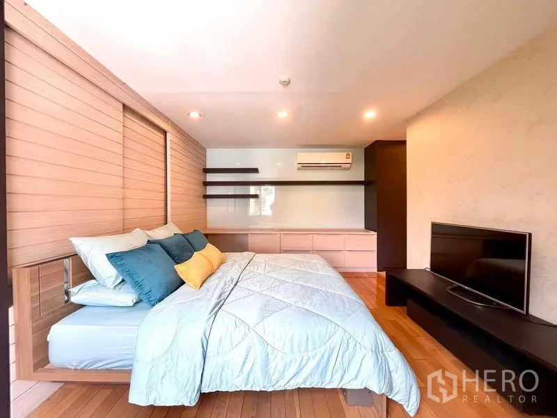Condominium for rent - Master bedroom view showing a TV console and full-length storage along the wall.