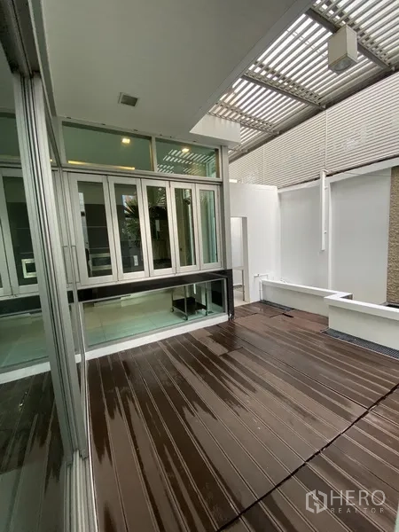 Townhouse for rent or sale in Chatuchak, Bangkok - Private decked patio with louvered canopy and sliding glass doors.