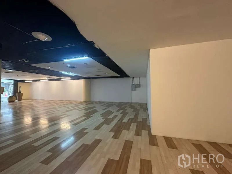Retail Space for rent - Wide retail floor leading toward the glass shopfront with ample lighting and power points.