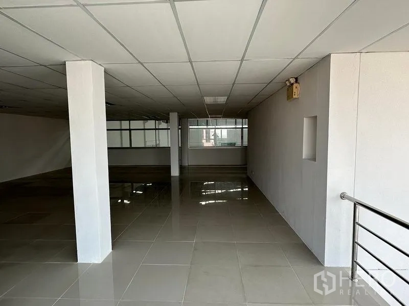 Warehouse for rent in Mueang Samut Prakan, Samut Prakan - Open-plan office floor with tiled flooring, drop ceiling and large windows inside the facility.