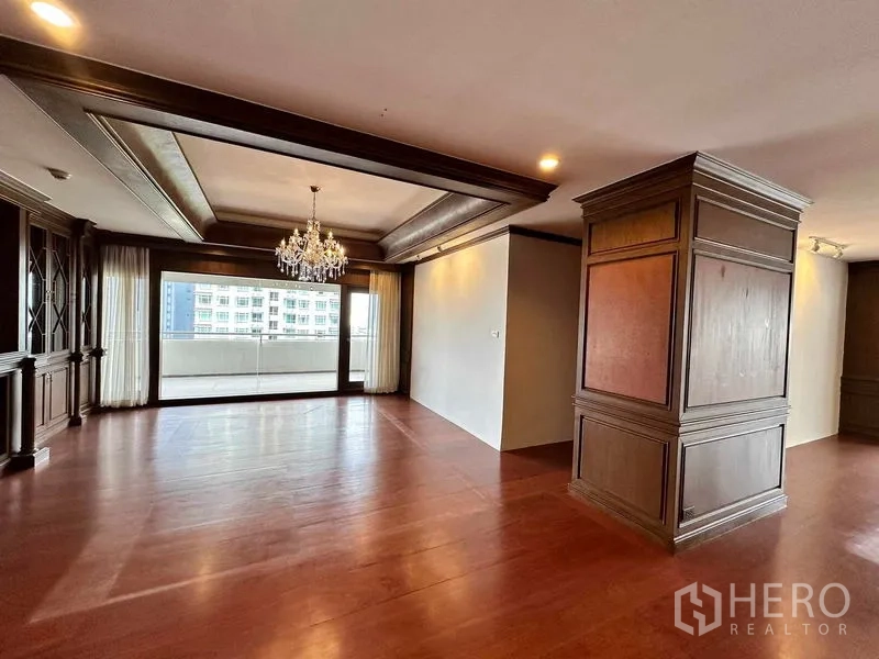Condominium for rent in Bangkok - Formal dining zone with coffered ceiling, chandelier and balcony view.
