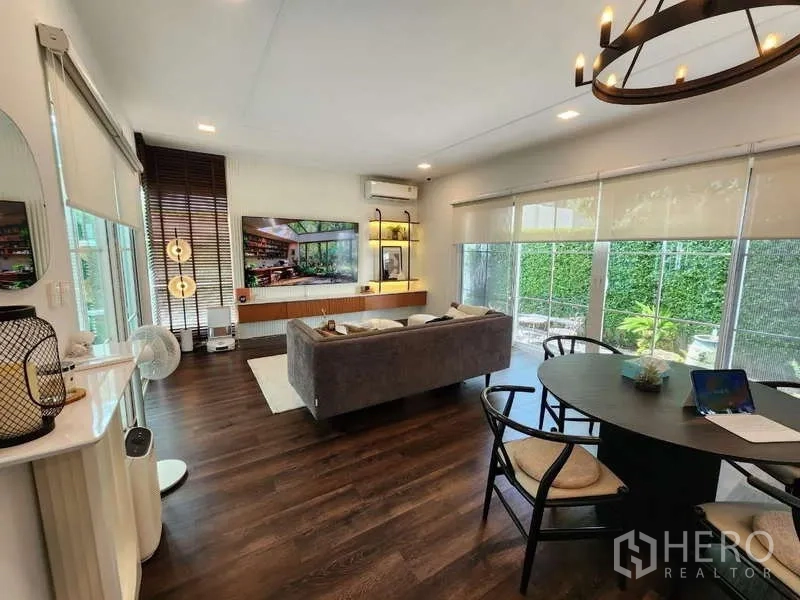 Detached House for rent or sale in Bang Phli, Samut Prakan - Open-plan living and dining area with large windows and garden views.