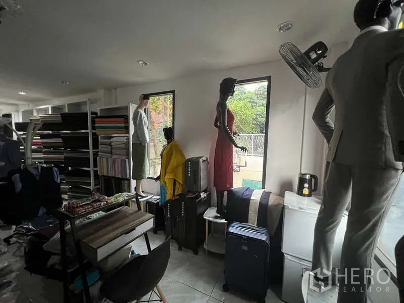 Retail Space for rent in Khlong Toei, Bangkok - Display area with windows overlooking greenery, shelving and luggage displays.