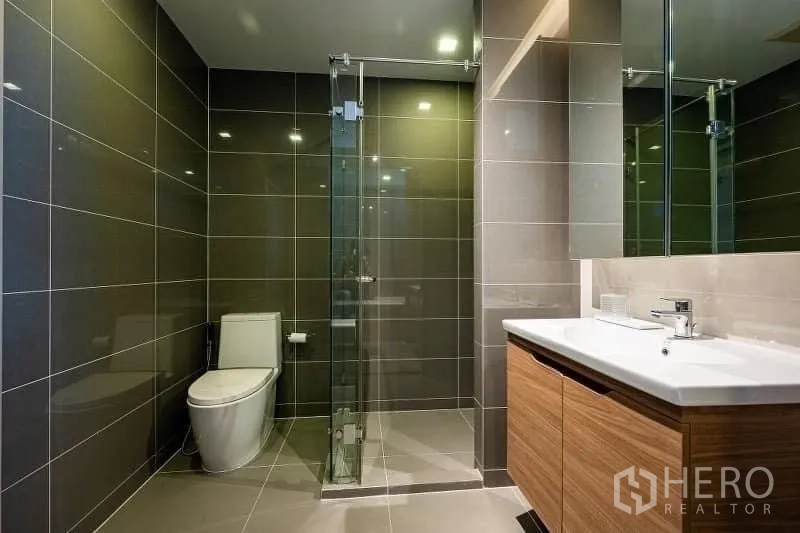 Condominium for sale - Second bathroom with walk-in shower, wood vanity and sleek fixtures.