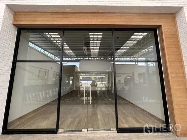 Retail Space for rent - Street-facing glass shopfront with double doors and warm timber surround.