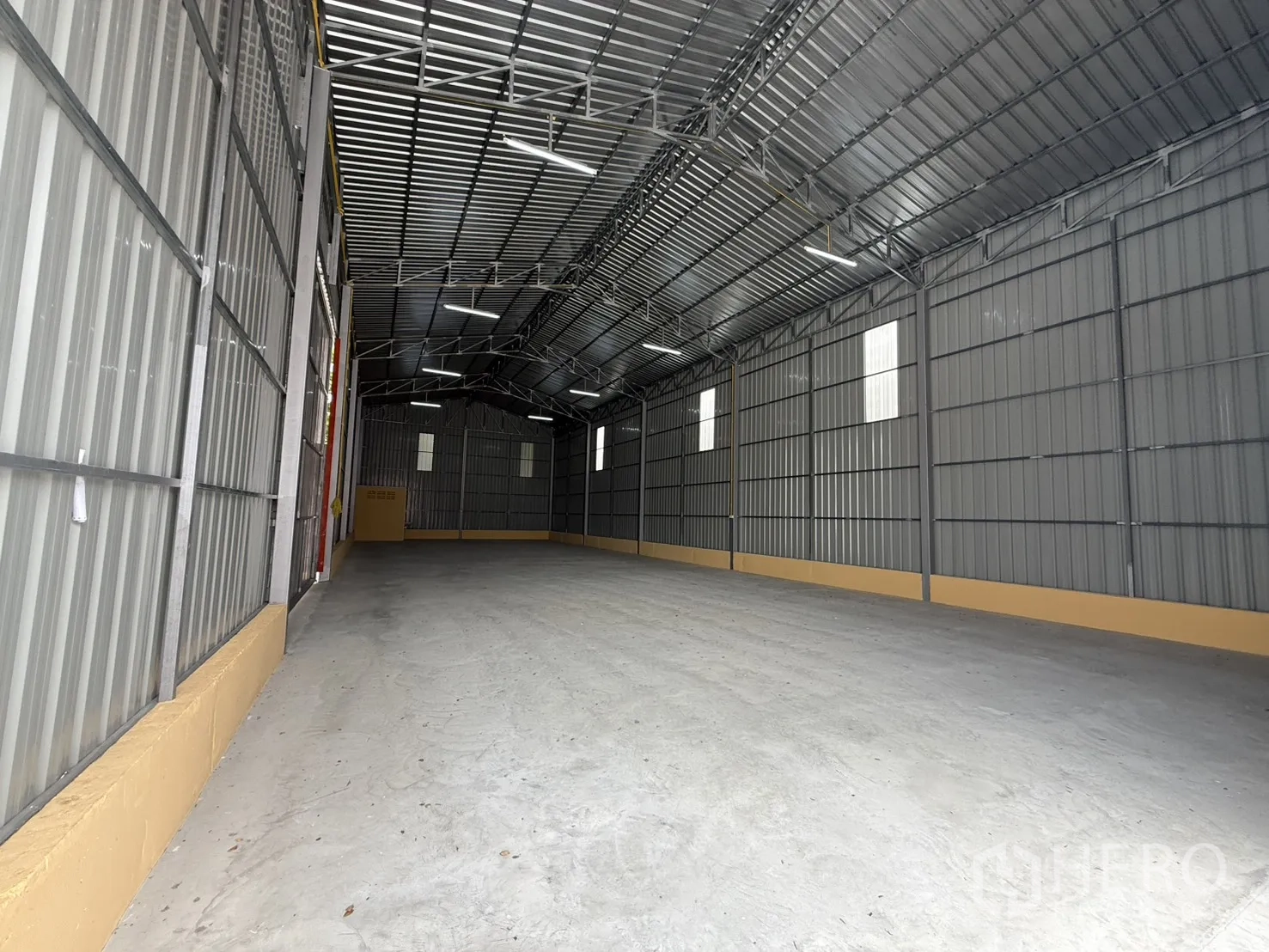 仓库 for rent in Wang Thonglang, Bangkok - 纵深开阔的仓库通道，设有采光板与顶灯。