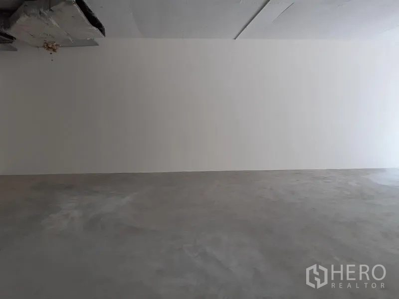 Retail Space for rent in Watthana, Bangkok - Blank white wall and concrete floor ideal for signage and flexible retail layouts.