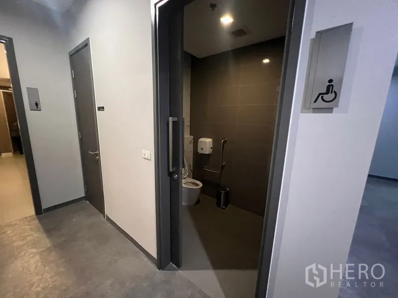 Office Space for rent - Accessible restroom with grab bars and modern fittings.