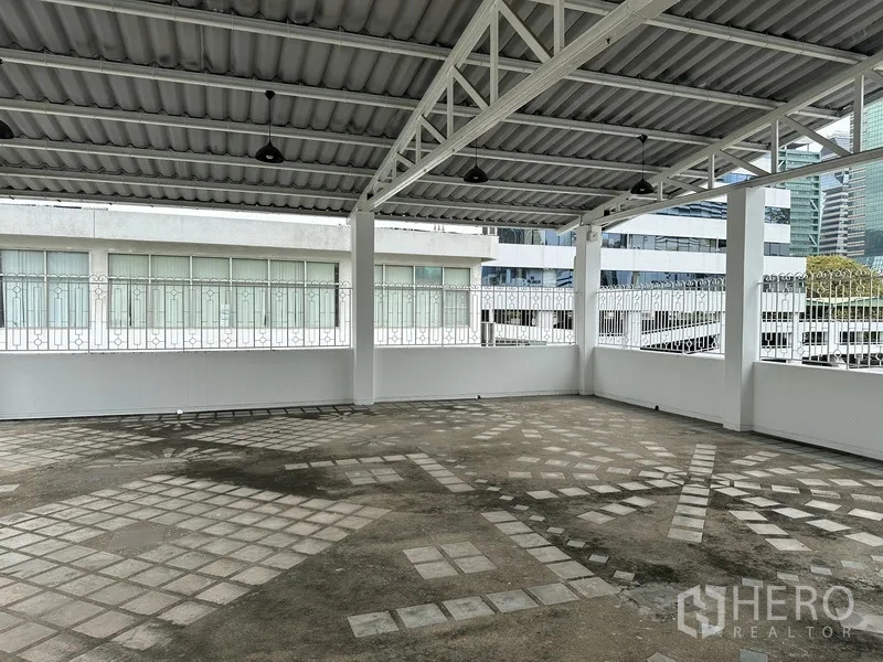 Retail Space for rent in Bang Rak, Bangkok - Wide covered outdoor area with steel truss roof and patterned concrete.
