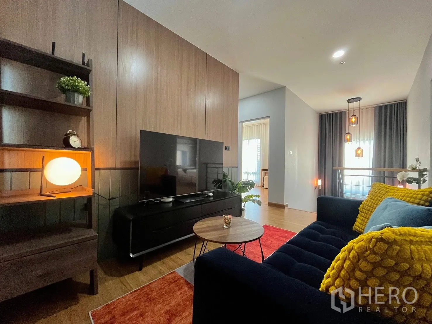 Detached House for rent in Bang Phli, Samut Prakan - Upstairs family lounge with sofa, TV wall, and warm wood accents.