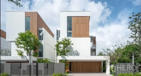 Detached House for rent in Saphan Sung, Bangkok - Modern detached house exterior with white and wood facade, balcony and covered garage.
