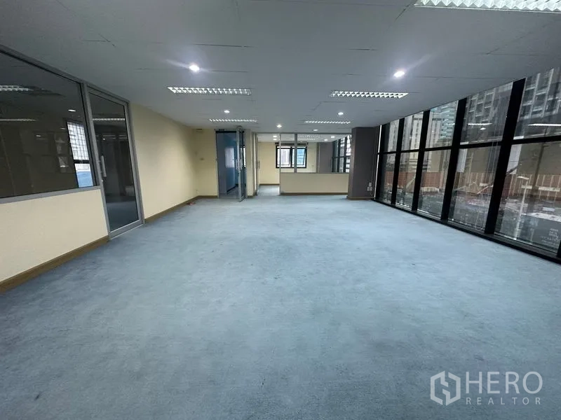 Office Space for rent in Bang Rak, Bangkok - Wide office zone with full-height glazing and bright ceiling lights.