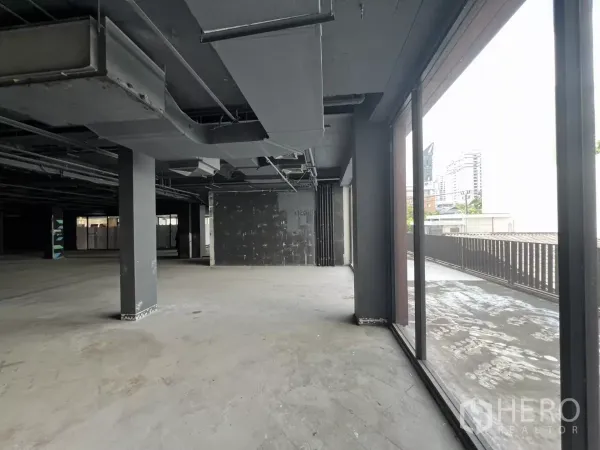 Retail Space for rent in Watthana, Bangkok - Shell-condition interior opening to the terrace through full-height glazing.