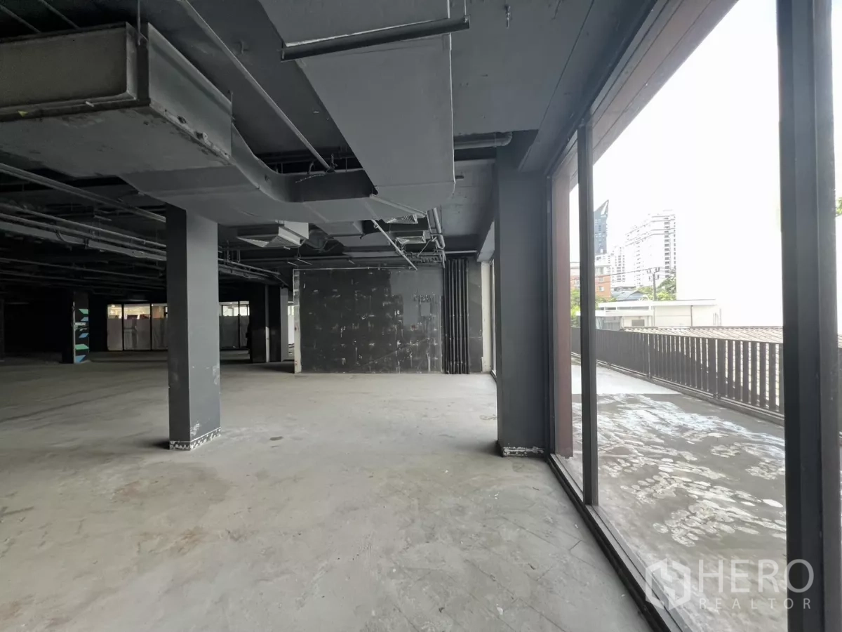 Retail Space for rent in Watthana, Bangkok - Shell-condition interior opening to the terrace through full-height glazing.
