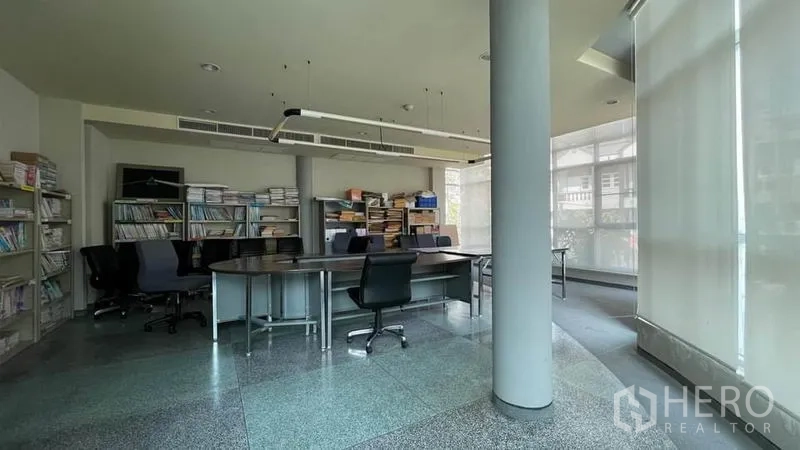 Warehouse for sale in Bangkok Yai, Bangkok - Glass‑walled meeting room with desks, shelving and natural light.