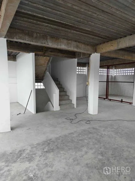 Warehouse for rent in Phra Khanong, Bangkok - Internal staircase connecting mezzanine levels in an industrial warehouse.