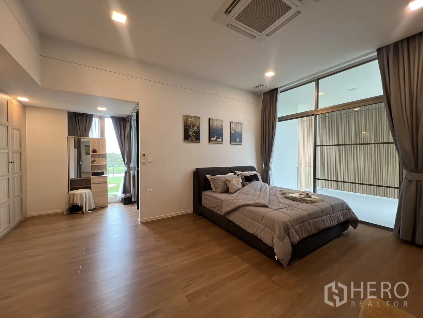 Detached House for rent in Saphan Sung, Bangkok - Master bedroom opening to a covered terrace with high ceilings and drapes.