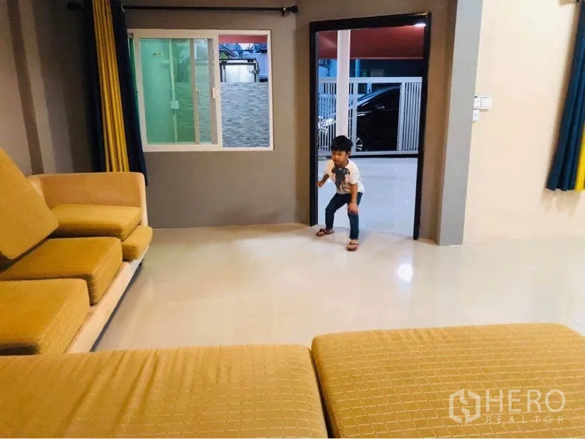 联排别墅 出租或出售在Huai Khwang, Bangkok - 客厅与前庭相连，设滑动窗与入户门。