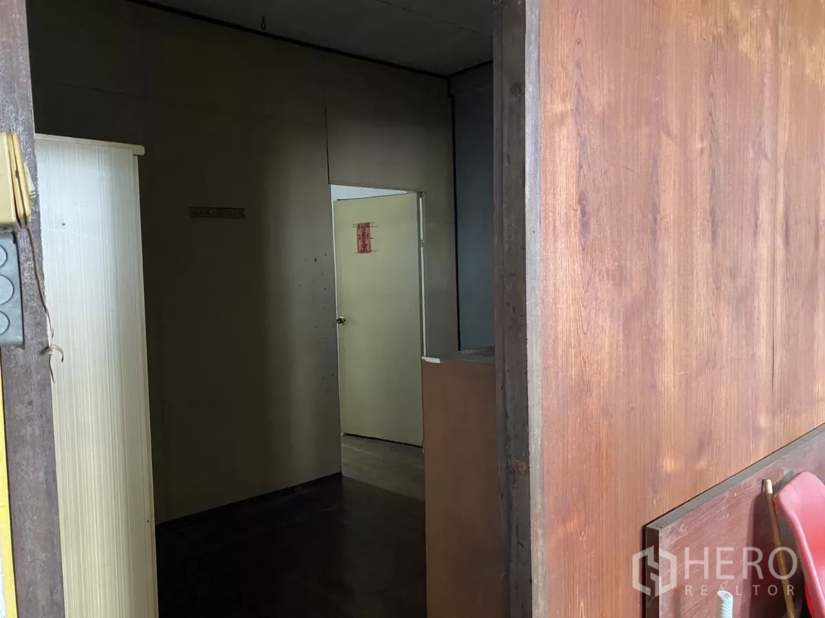 Shophouse for rent in Khlong Toei, Bangkok - Upstairs corridor with wooden partitions leading to rooms.