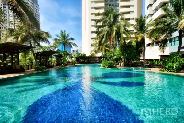 Condominium for rent in Sathon, Bangkok - Large resort-style swimming pool with palm trees, cabanas and city high-rise views.