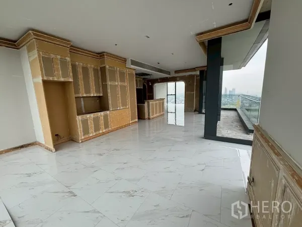 Condominium for sale in Bang Kho Laem, Bangkok - Open-plan kitchen and dining area with built-in cabinetry connecting to a large terrace.