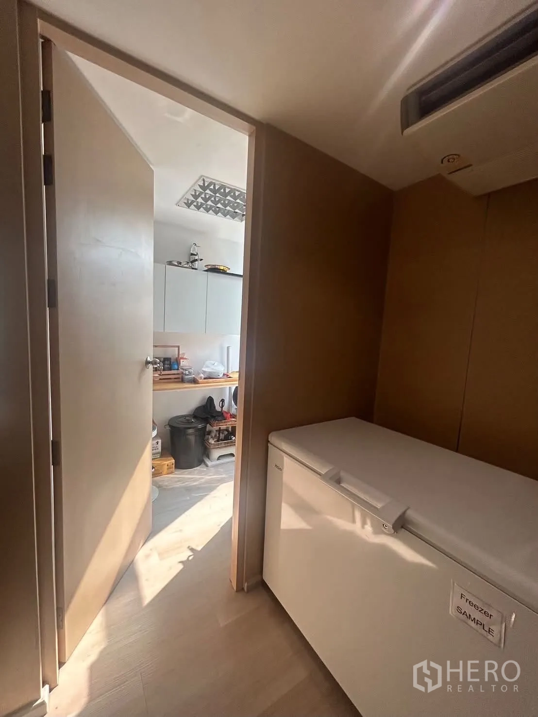 Office Space for rent in Bang Rak, Bangkok - Hallway with chest freezer leading to utility room with sink and wall cabinets