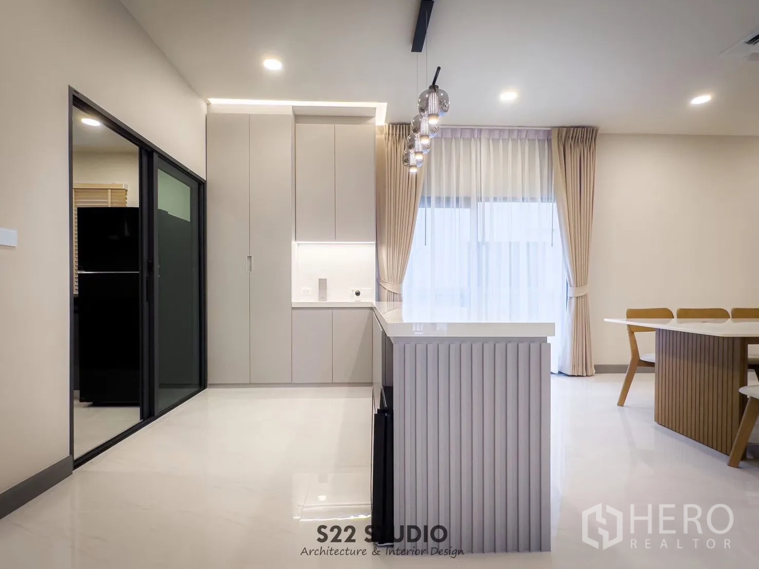 独立式住宅 出租在Bang Phli, Samut Prakan - 厨房岛台与高柜，旁为推拉门通往中厨