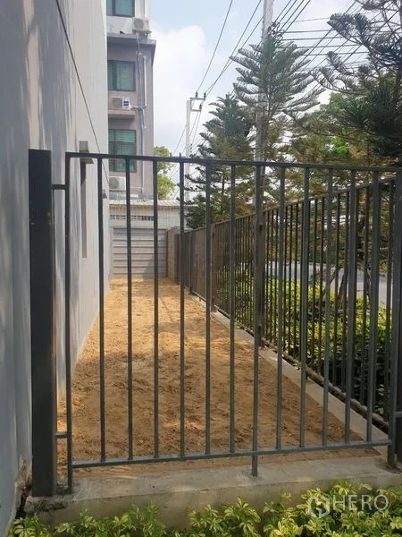 Home Office for rent - Gated side yard with walkway and planting strip beside the building.