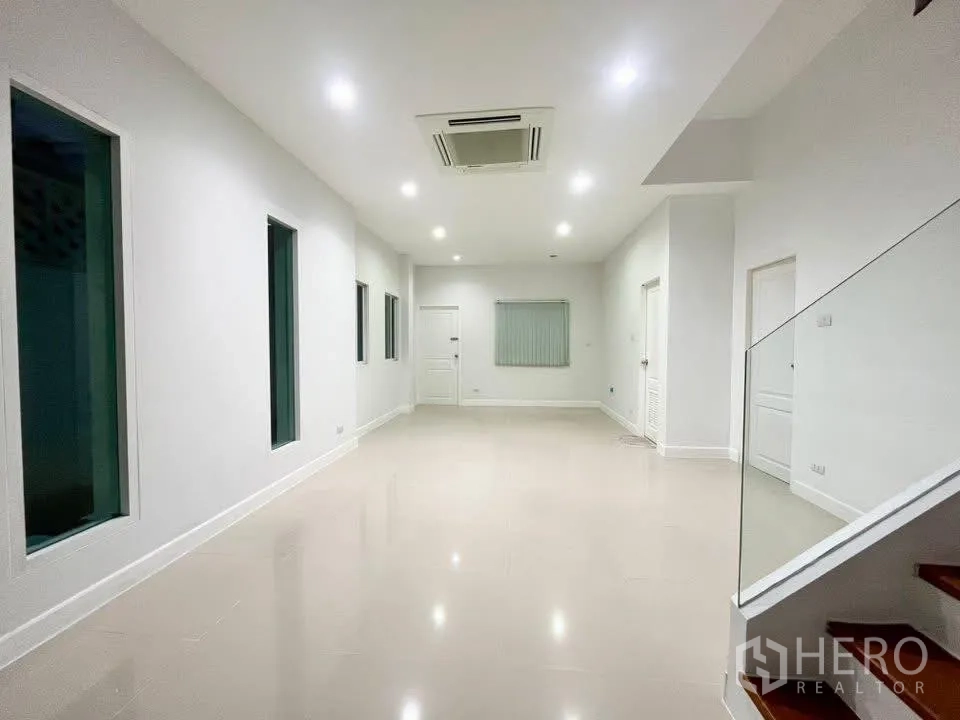 Home Office for rent in Bueng Kum, Bangkok - Long, bright hall on lower floor with recessed lighting and glass stair rail