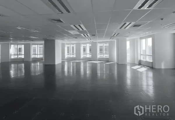 Office Space for rent - Corner office area with large windows, city outlooks, and raised tile flooring under ceiling air vents.