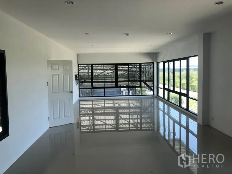 Factory for rent or sale in Bang Bo, Samut Prakan - Bright upstairs office with large corner windows overlooking the factory floor.