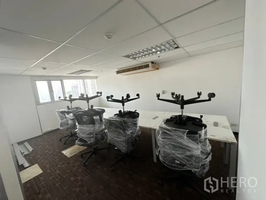 办公空间 出租在Watthana, Bangkok - 开放式工位区，包膜的新办公椅与长桌，临窗采光。