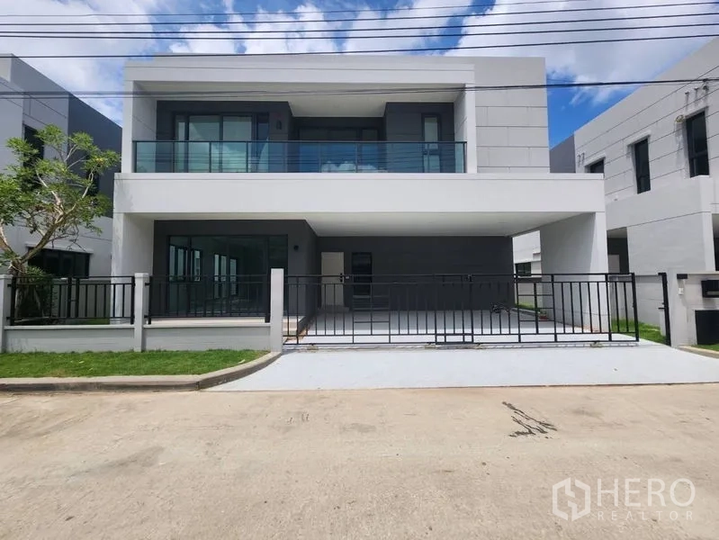 Detached House for rent in Bang Phli, Samut Prakan - Modern two-storey detached house with balcony, gated frontage and driveway.