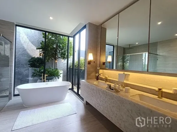 Detached House for sale - Spa‑style bathroom with double vanity, freestanding tub and floor‑to‑ceiling garden window.