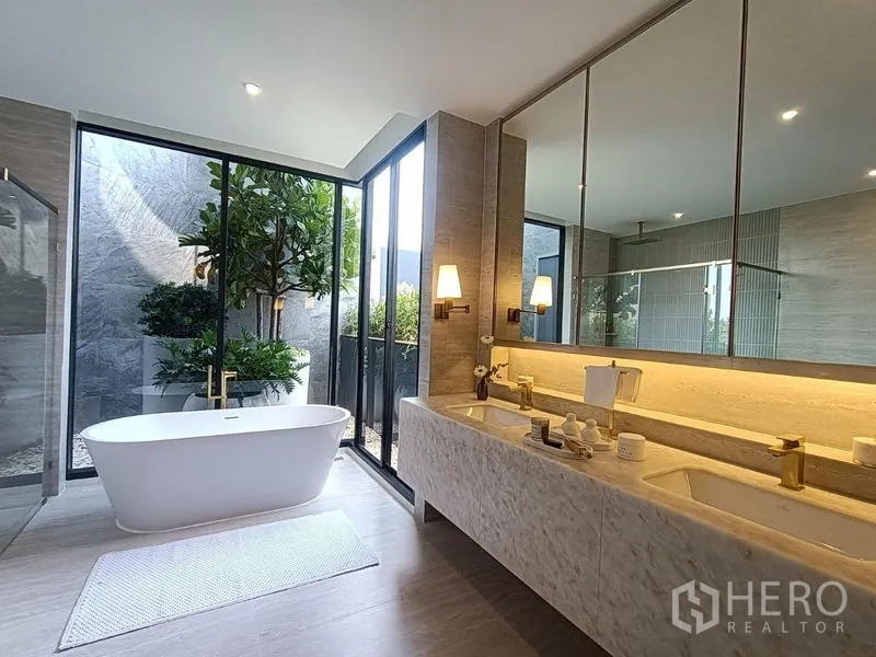 Detached House for sale - Spa‑style bathroom with double vanity, freestanding tub and floor‑to‑ceiling garden window.