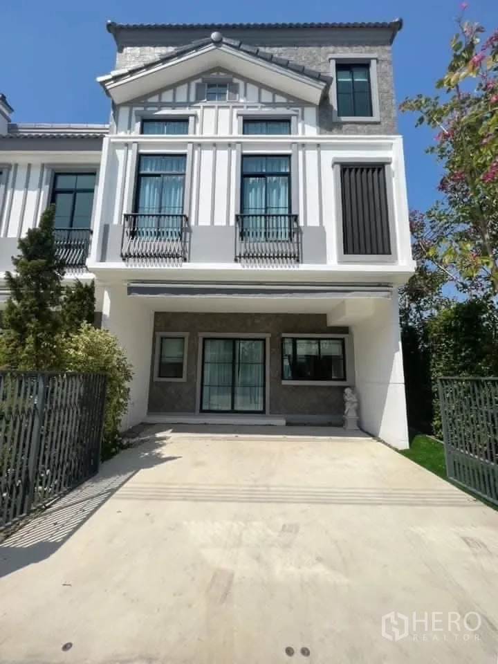 Townhouse for rent in Bang Phli, Samut Prakan - Townhouse exterior with an elegant facade, gated driveway, and covered carport.